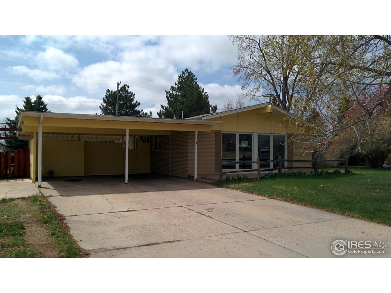 2478 25th Street Road Greeley, CO 80634 - Photo 3 of 19 a black and white building with trees in the background