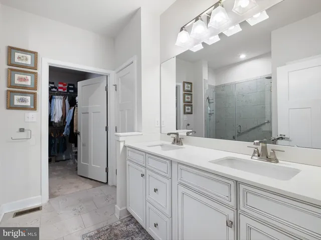 a bathroom with a sink vanity and a mirror