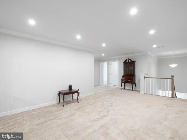 an empty room with furniture and a ceiling fan