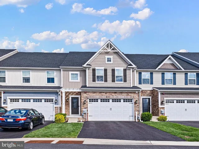 a view of multiple houses with a yard
