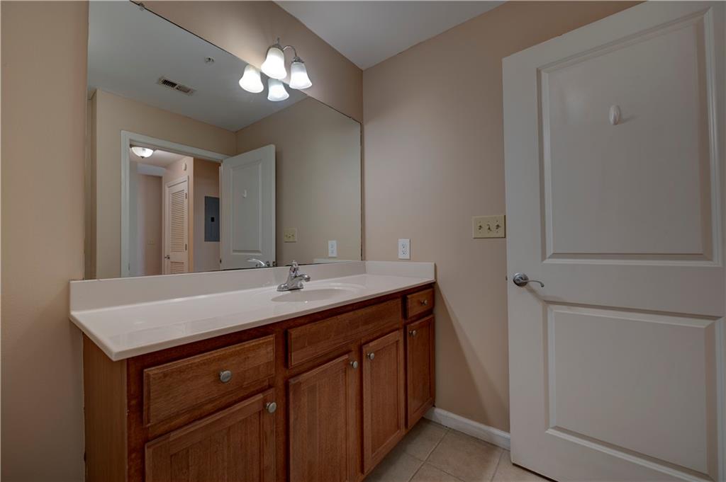 3040 Peachtree Road, Unit 813 Atlanta, GA 30305 - Photo 13 of 28 a bathroom with a sink and a mirror