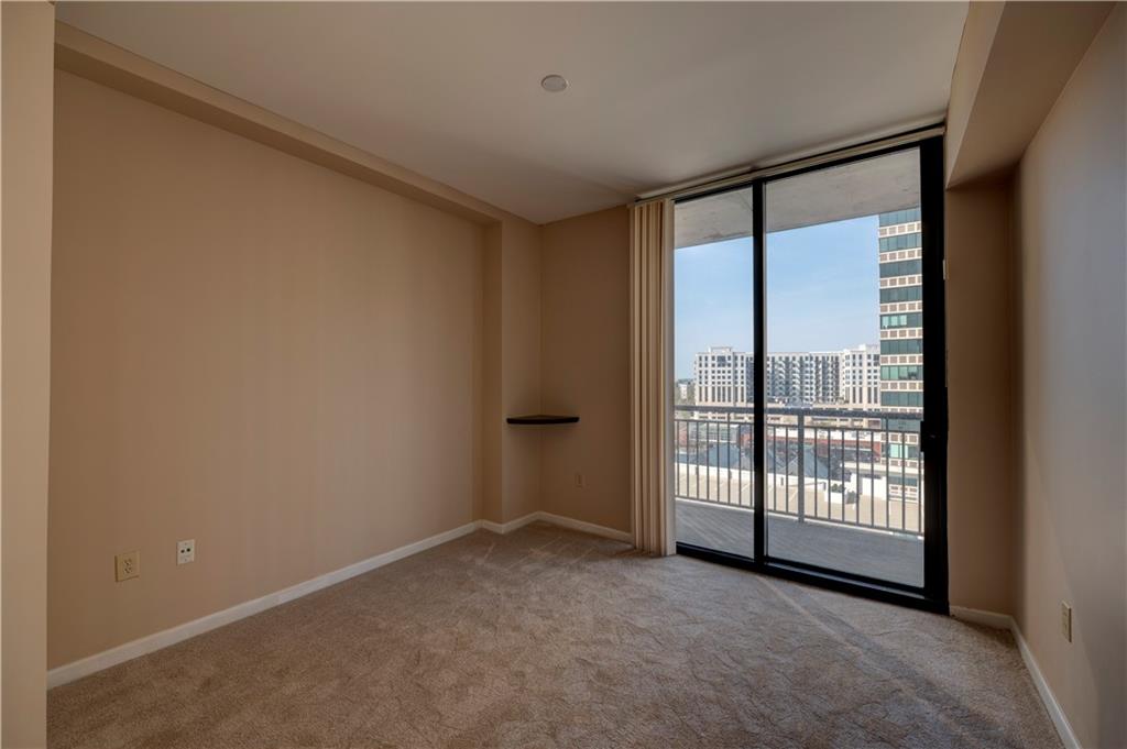 3040 Peachtree Road, Unit 813 Atlanta, GA 30305 - Photo 15 of 28 a view of an empty room with glass door