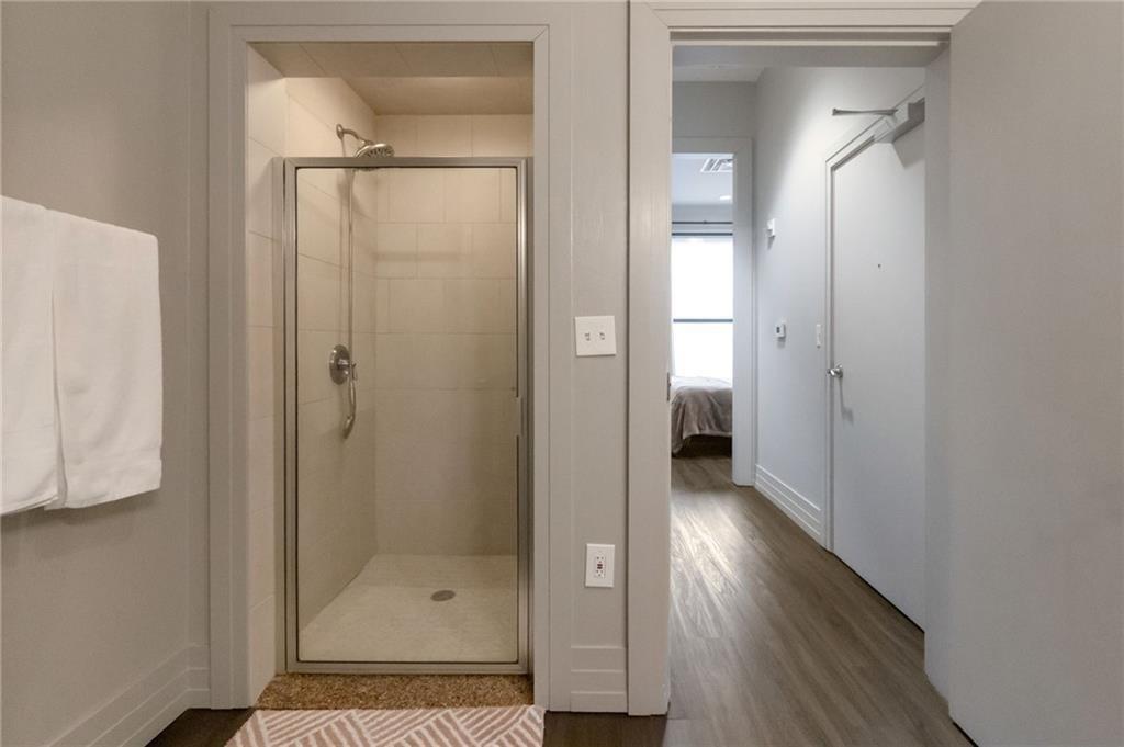 3040 Peachtree Road, Unit 813 Atlanta, GA 30305 - Photo 20 of 28 a bathroom with a glass shower door