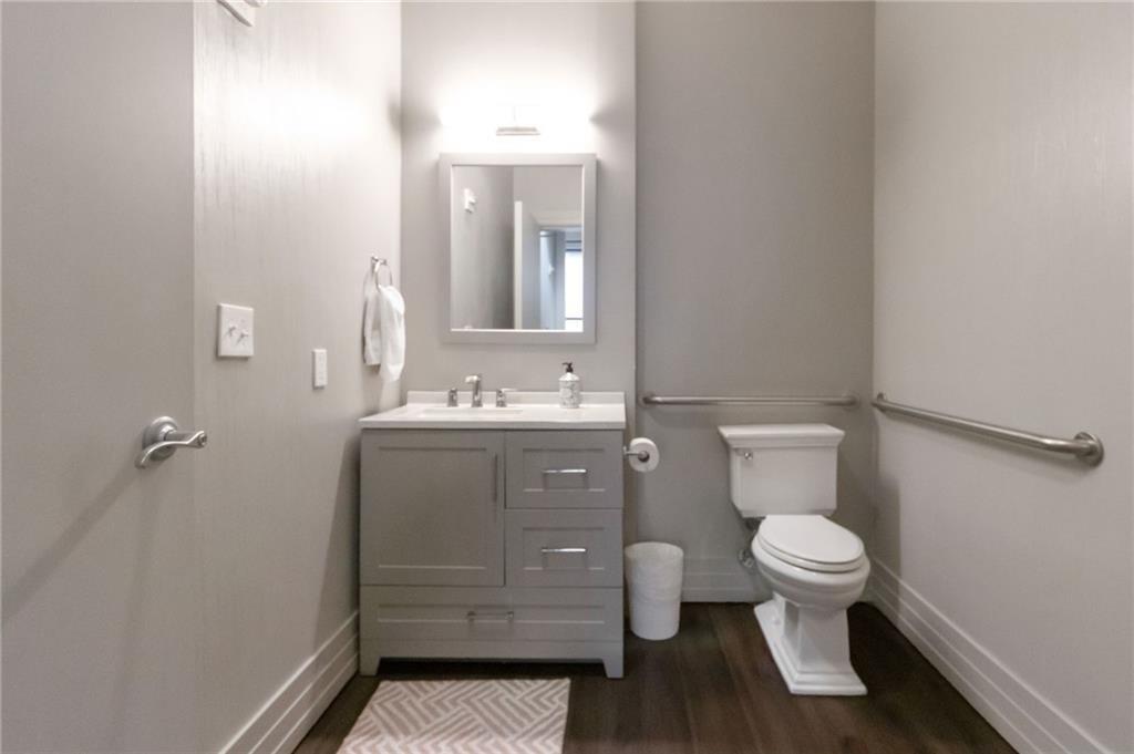 3040 Peachtree Road, Unit 813 Atlanta, GA 30305 - Photo 21 of 28 a bathroom with a sink a toilet a mirror and shower