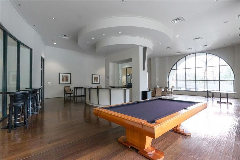3040 Peachtree Road, Unit 813 Atlanta, GA 30305 - Photo 26 of 28 a living room with pool table and wooden floor
