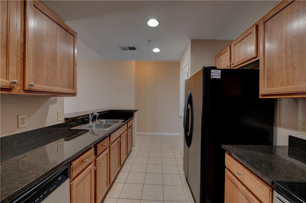 3040 Peachtree Road, Unit 813 Atlanta, GA 30305 - Photo 4 of 28 a kitchen with a sink and refrigerator