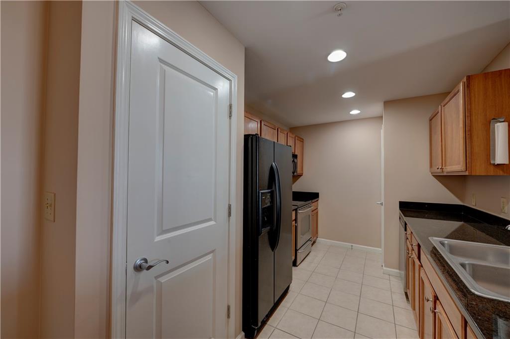 3040 Peachtree Road, Unit 813 Atlanta, GA 30305 - Photo 5 of 28 a kitchen with a refrigerator and a sink