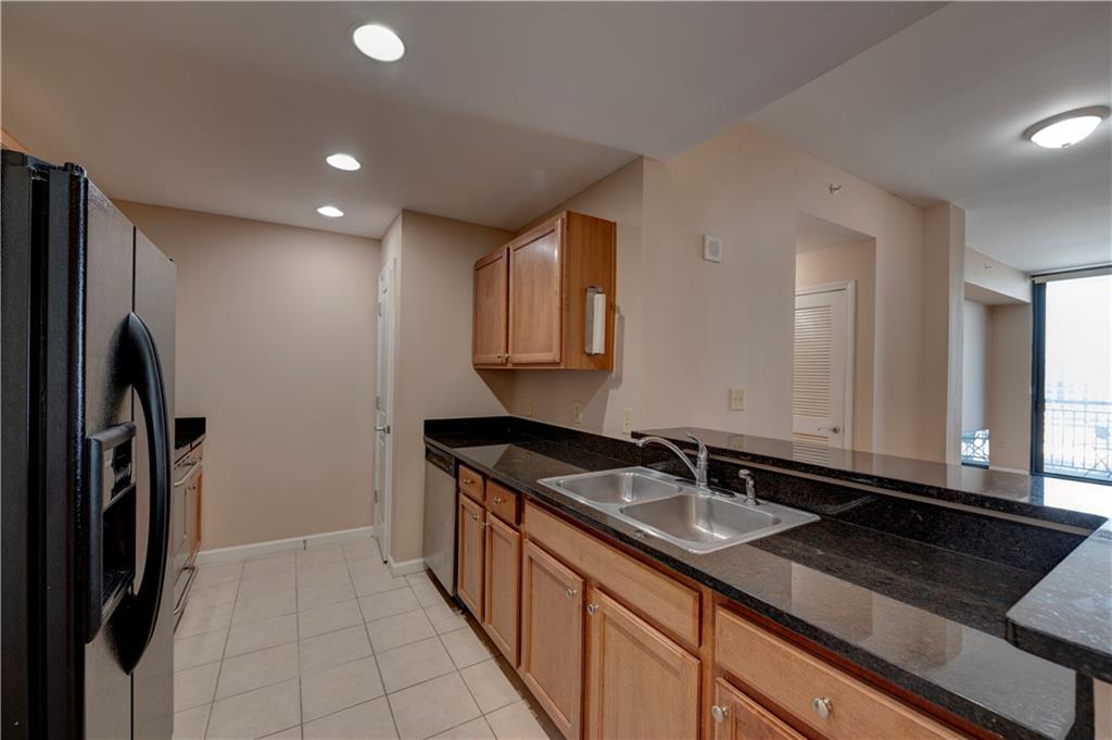 3040 Peachtree Road, Unit 813 Atlanta, GA 30305 - Photo 7 of 28 a kitchen with a sink and cabinets