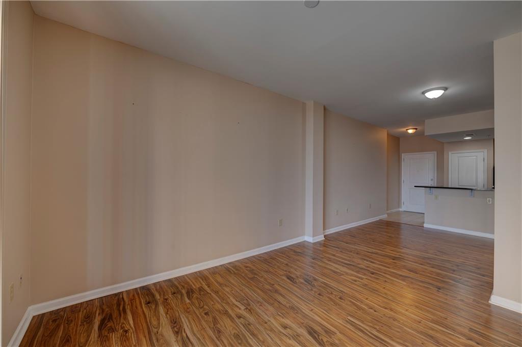 3040 Peachtree Road, Unit 813 Atlanta, GA 30305 - Photo 9 of 28 a view of an empty room with wooden floor