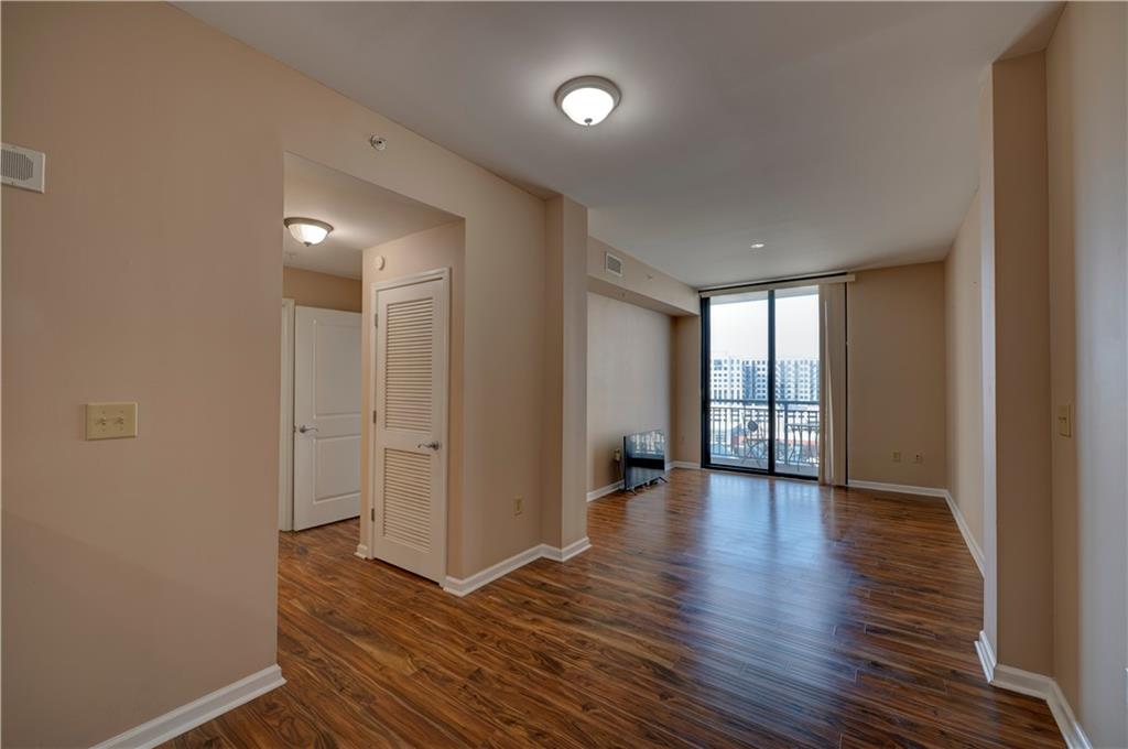 3040 Peachtree Road, Unit 813 Atlanta, GA 30305 - Photo 10 of 28 a view of an empty room with glass door and wooden floor