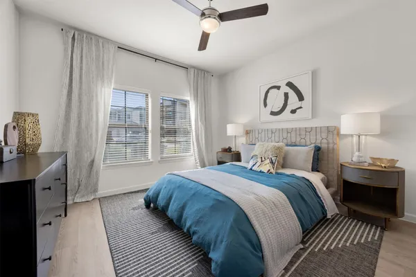 a bedroom with a large bed and a window