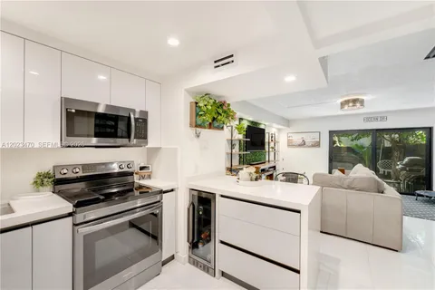 a kitchen with a sink stove and microwave