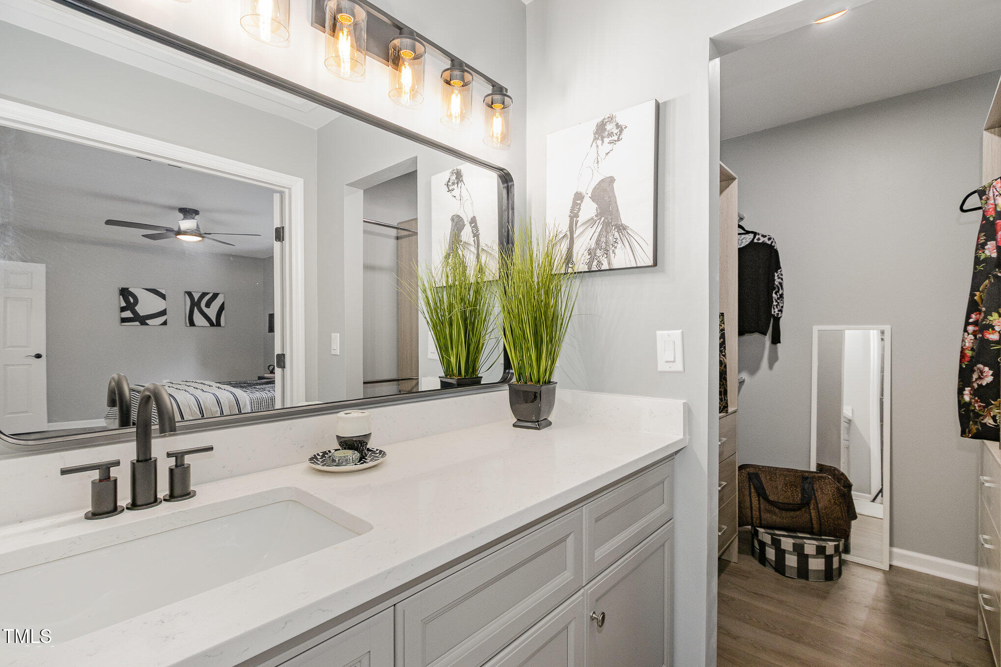 7708 Falcon Rest Circle Raleigh, NC 27615 - Photo 13 of 23 Expansive vanity and storage, walk-in closet on the right, tiled glass enclosed shower on left.