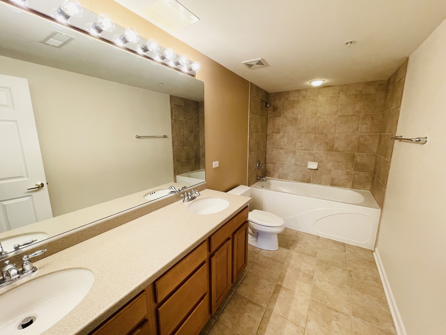 601 West Rand Road, Unit 315 Arlington Heights, IL 60004 - Photo 4 of 12 a bathroom with a sink double vanity granite tub shower and a mirror