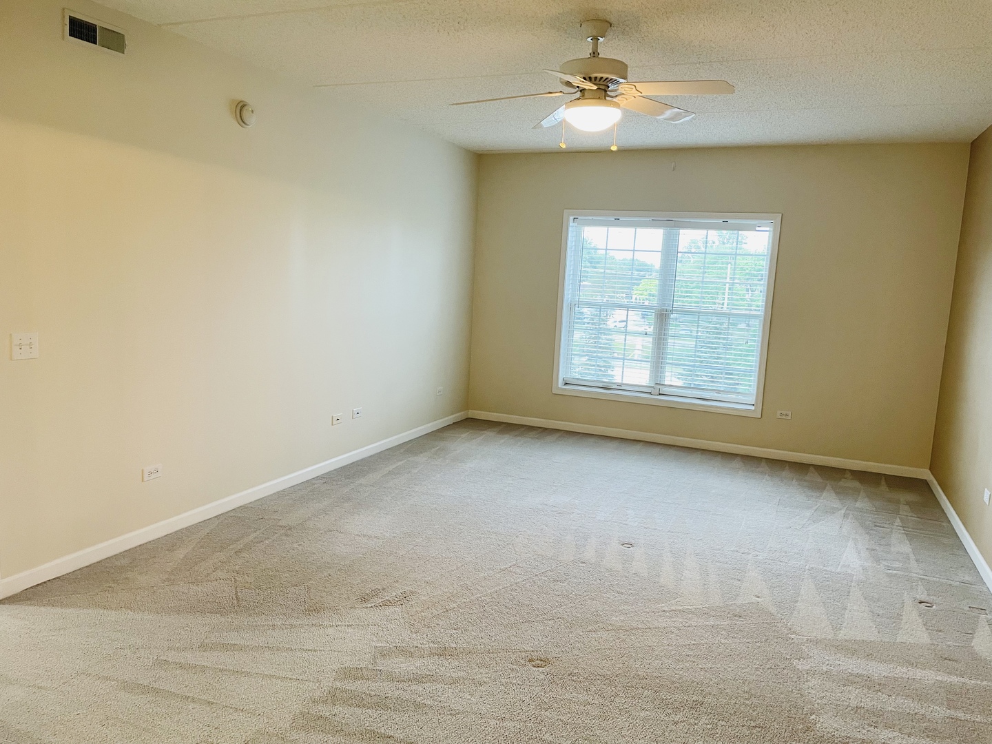 601 West Rand Road, Unit 315 Arlington Heights, IL 60004 - Photo 5 of 12 an empty room with a window and a fan