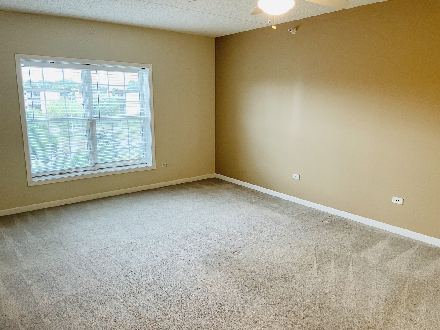601 West Rand Road, Unit 315 Arlington Heights, IL 60004 - Photo 8 of 12 an empty room with a empty space and a window