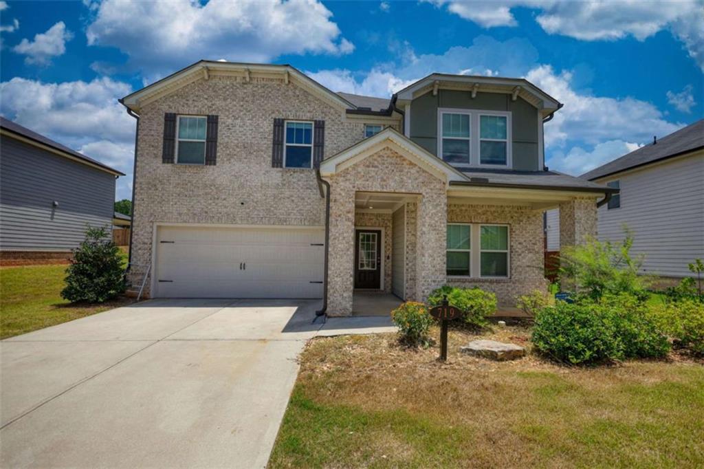a front view of a house with garden