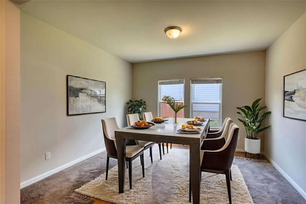 719 Sara Meadow Road Loganville, GA 30052 - Photo 16 of 74 a dining room with furniture and window