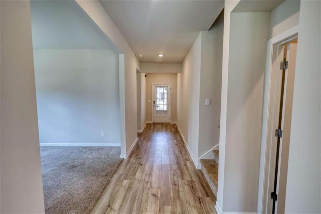 719 Sara Meadow Road Loganville, GA 30052 - Photo 20 of 74 a view of a hallway with wooden floor