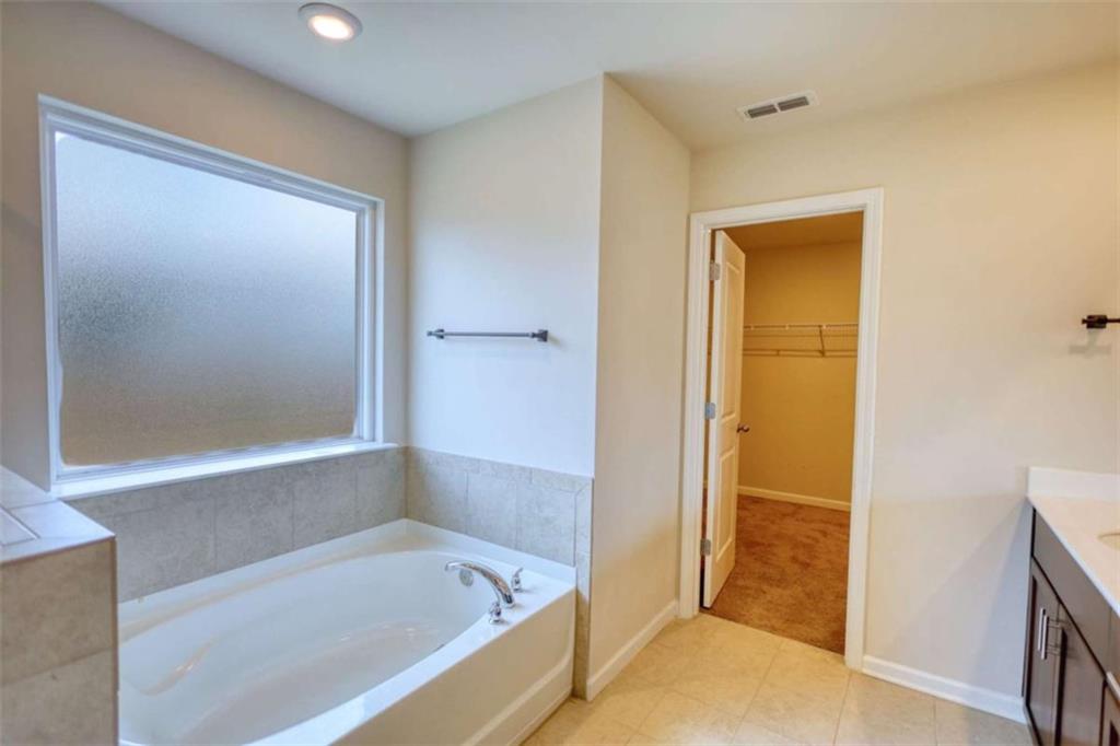 719 Sara Meadow Road Loganville, GA 30052 - Photo 41 of 74 a bathroom with a bathtub and a shower