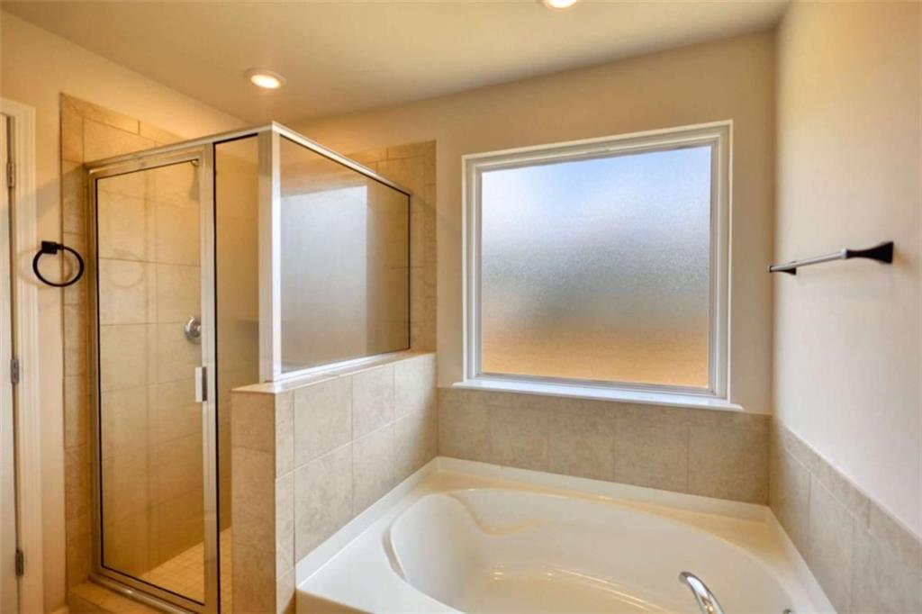 719 Sara Meadow Road Loganville, GA 30052 - Photo 42 of 74 a bathroom with a bathtub and a shower