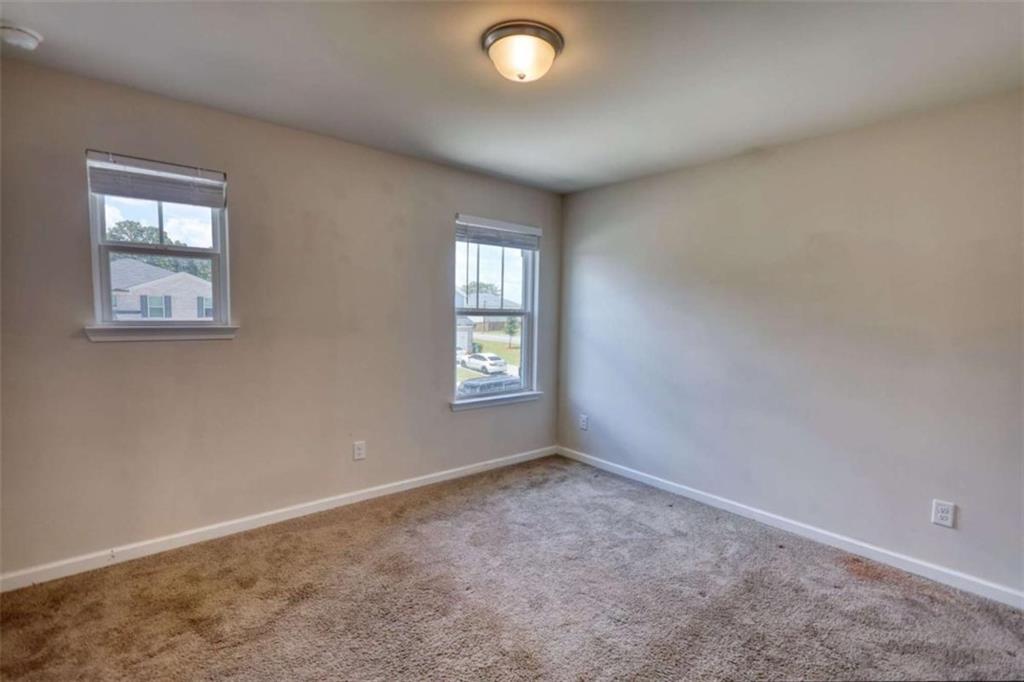 719 Sara Meadow Road Loganville, GA 30052 - Photo 50 of 74 an empty room with windows and closet area