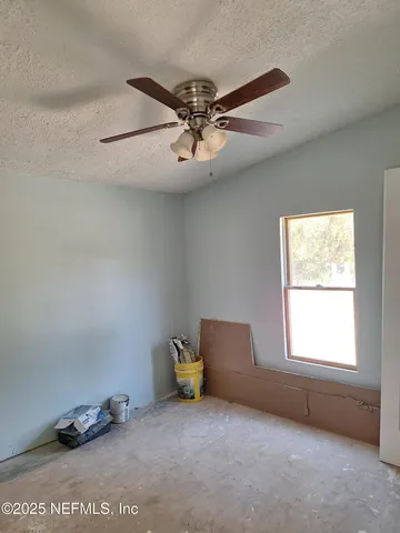 a view of a room with gym equipment and a window