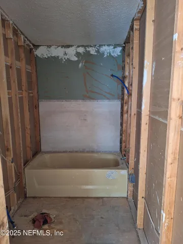 a bathroom with a tub and a shower
