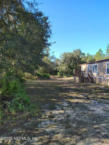 a view of a water fountain with large trees