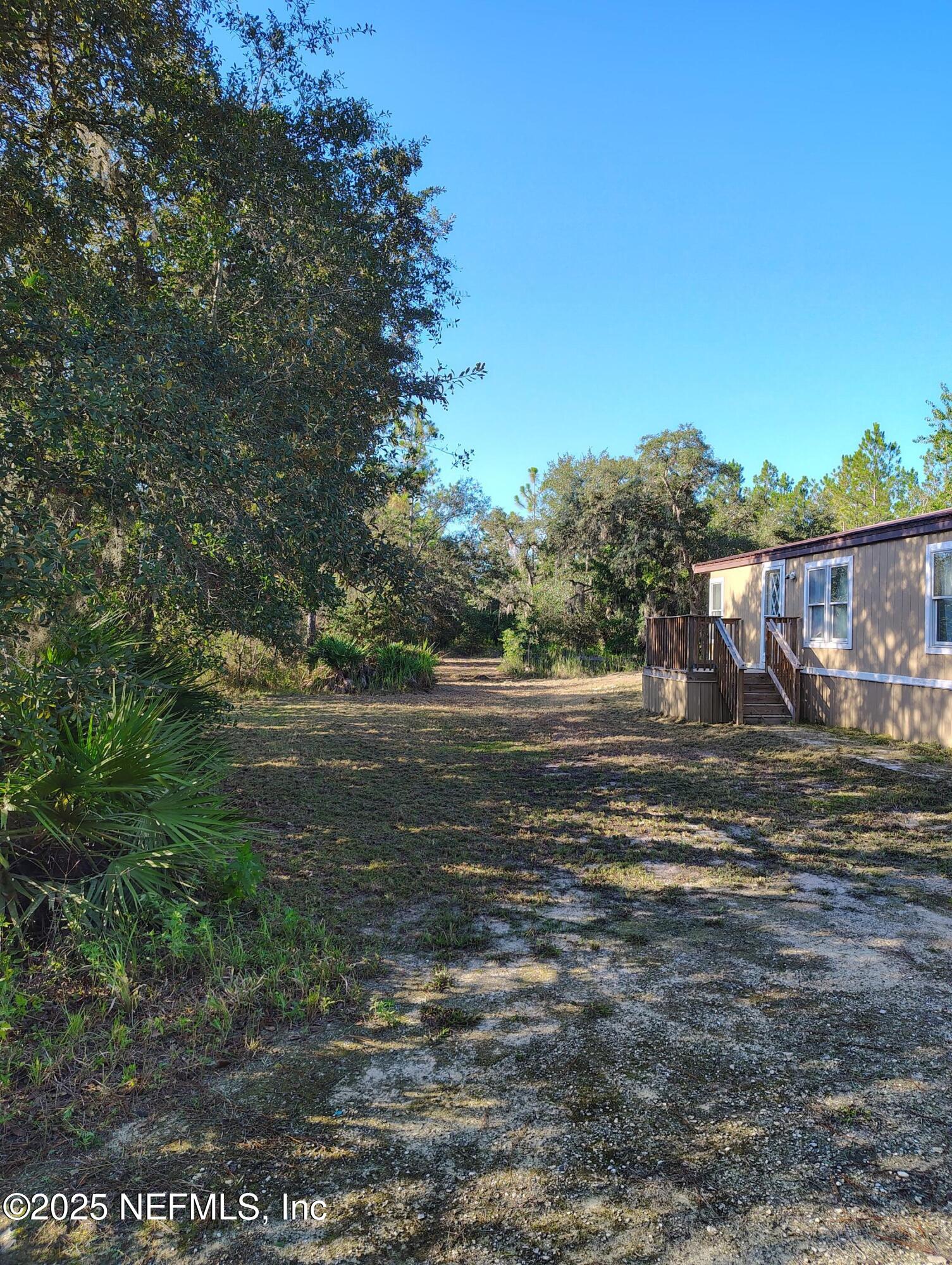 601 Hoover Road Interlachen, FL 32148 - Photo 3 of 33 a view of a water fountain with large trees