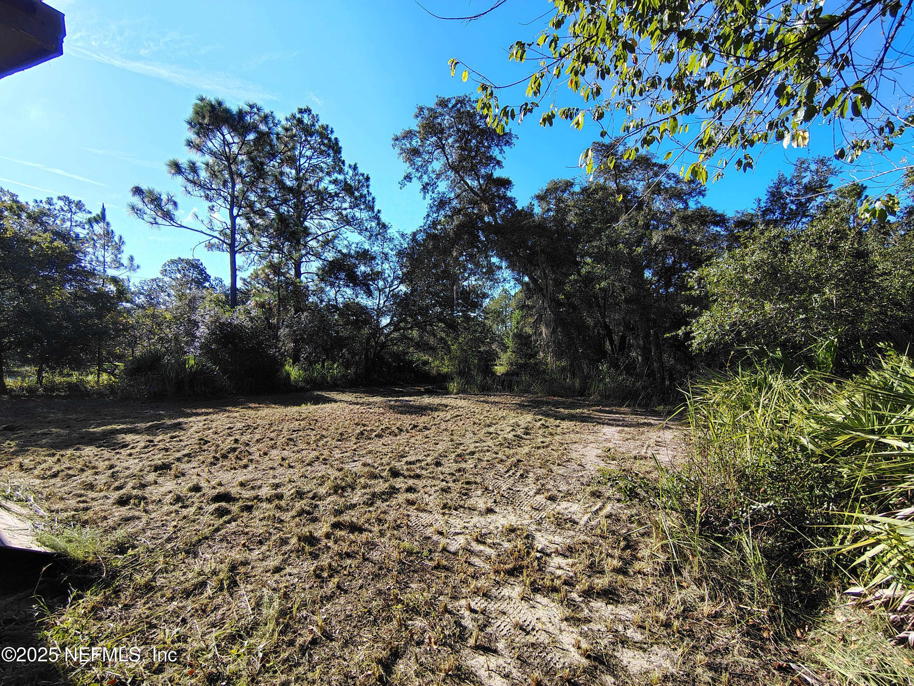 601 Hoover Road Interlachen, FL 32148 - Photo 6 of 33 a wooden bench with view of trees