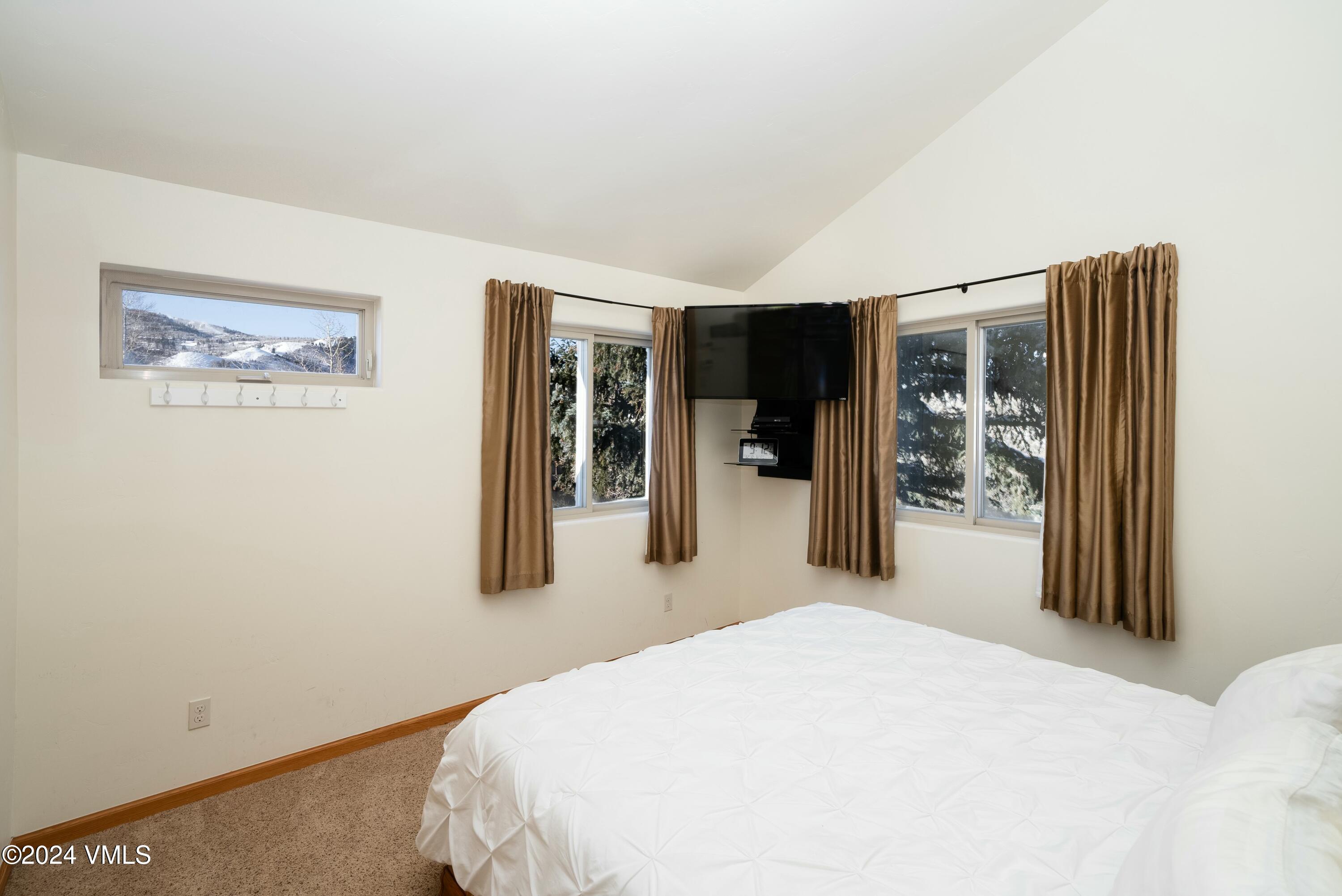 228-238 West Beaver Creek Boulevard, Unit A & B Avon, CO 81620 - Photo 26 of 72 a bedroom with a bed and a large mirror