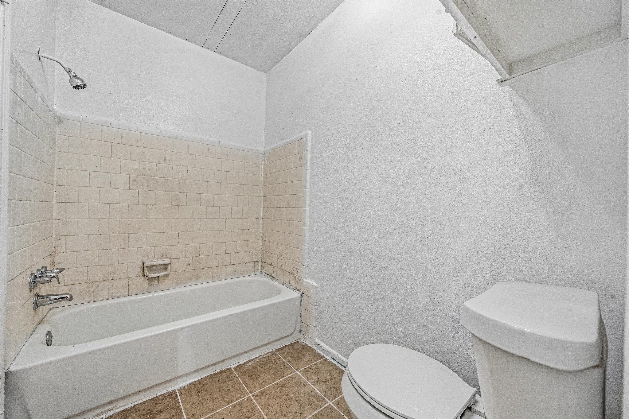 12054 Beechnut Street Houston, TX 77072 - Photo 12 of 21 a white bath tub sitting next to a white toilet