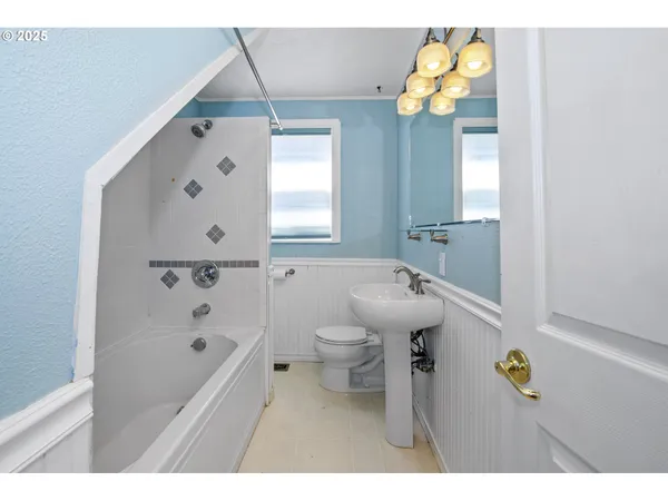 a bathroom with a sink a toilet and a bathtub