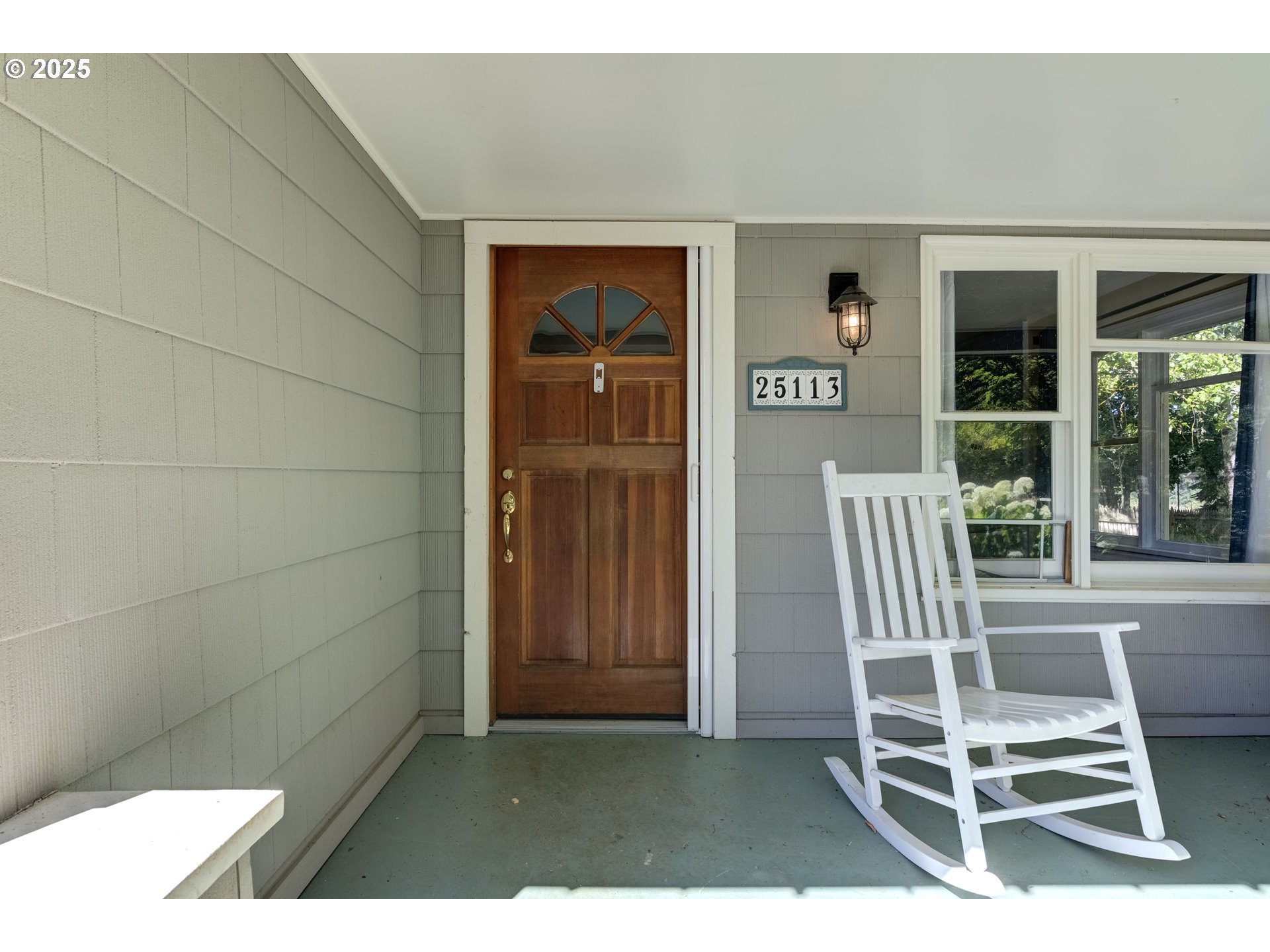 25113 South Ridge Road Beavercreek, OR 97004 - Photo 3 of 43 a balcony with a table and chairs