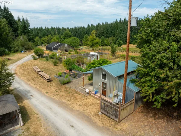 an aerial view of a house with a yard basket ball court and outdoor seating