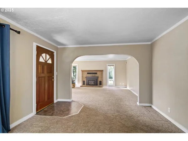 a view of an empty room with a fireplace