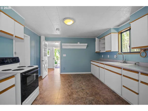 a kitchen with a stove and a sink