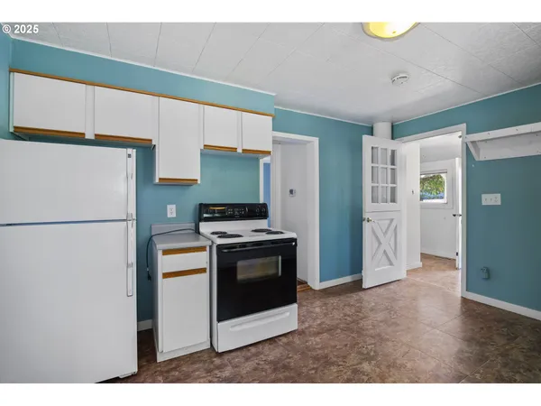 a kitchen with stainless steel appliances a refrigerator sink and stove