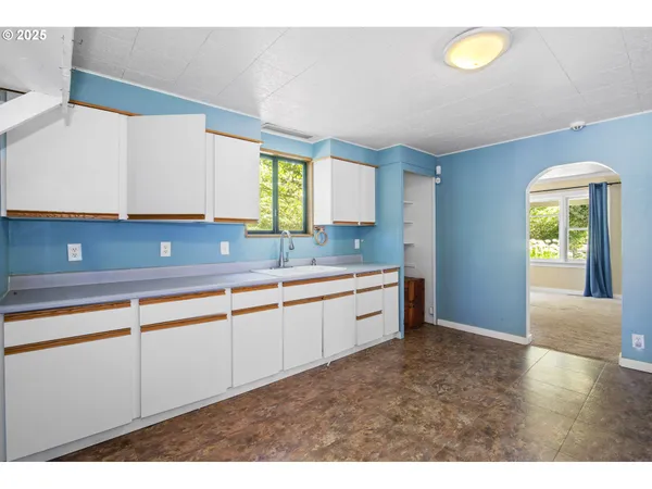 a kitchen with granite countertop a sink and a window