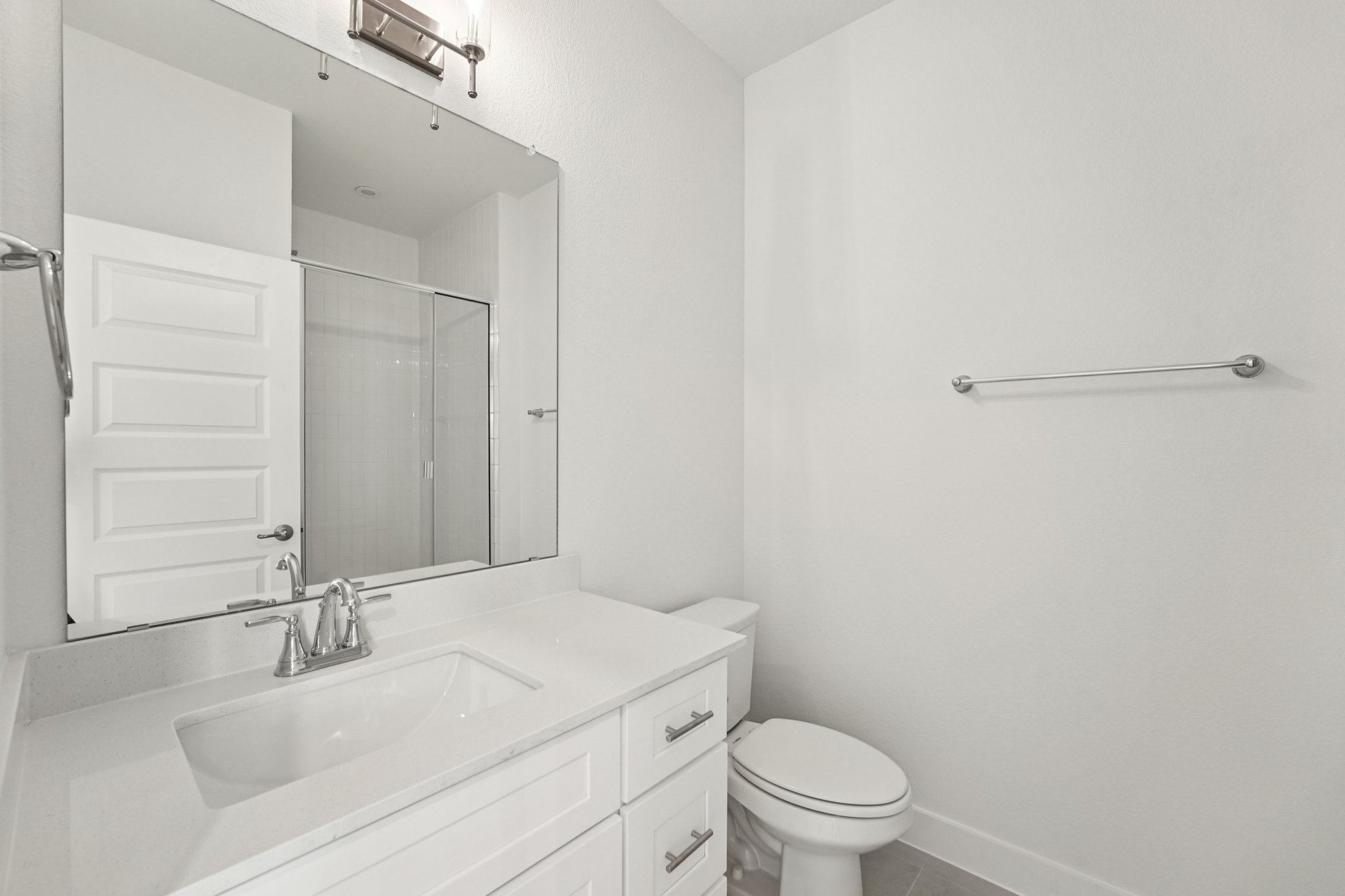 200 West 56th Street, Unit 5103 Austin, TX 78751 - Photo 19 of 29 a bathroom with a sink a toilet and a mirror