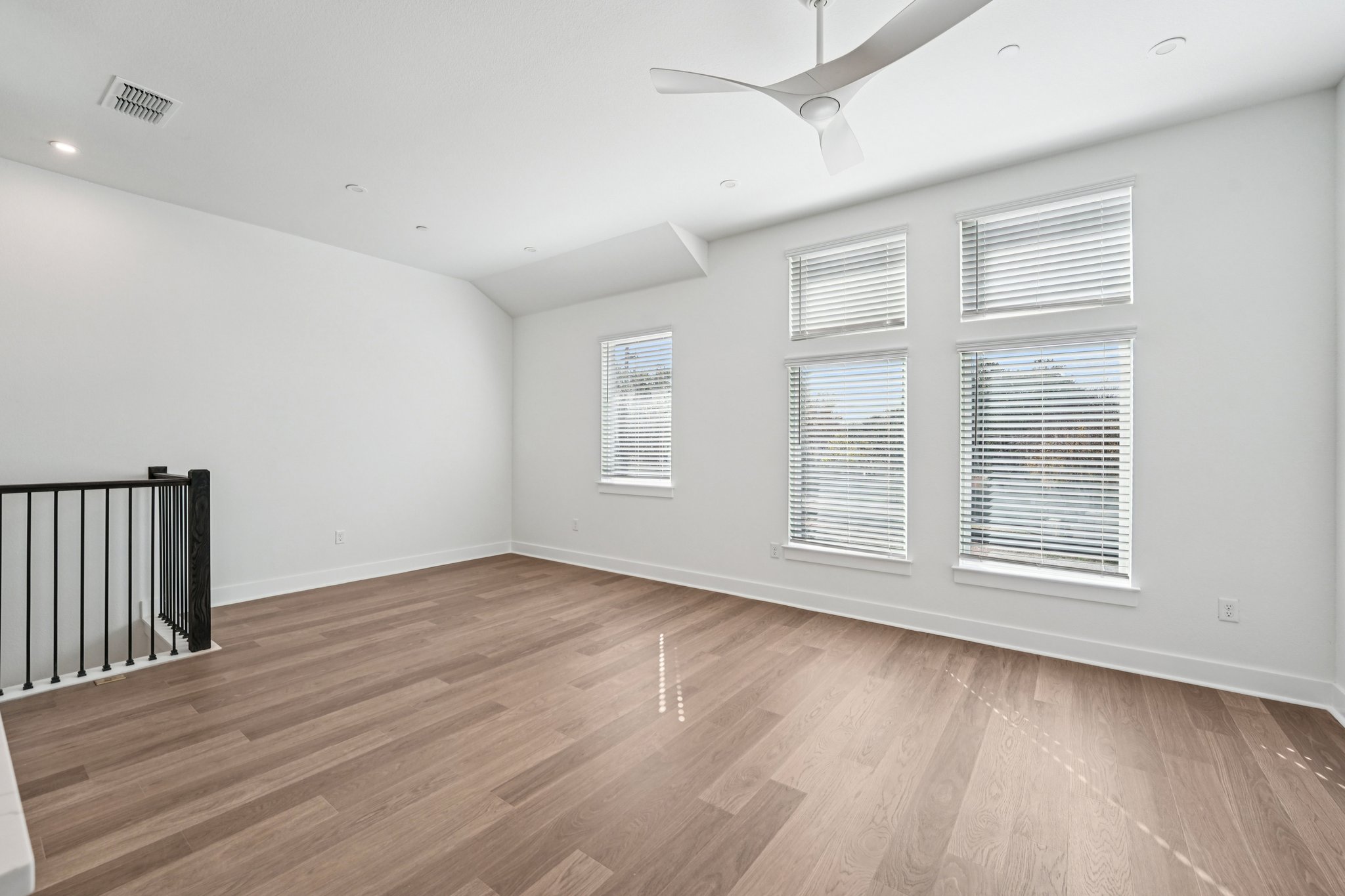 200 West 56th Street, Unit 5103 Austin, TX 78751 - Photo 3 of 29 an empty room with wooden floor and windows