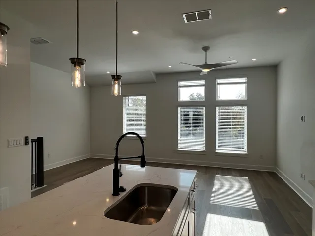 a kitchen with a sink and chandelier