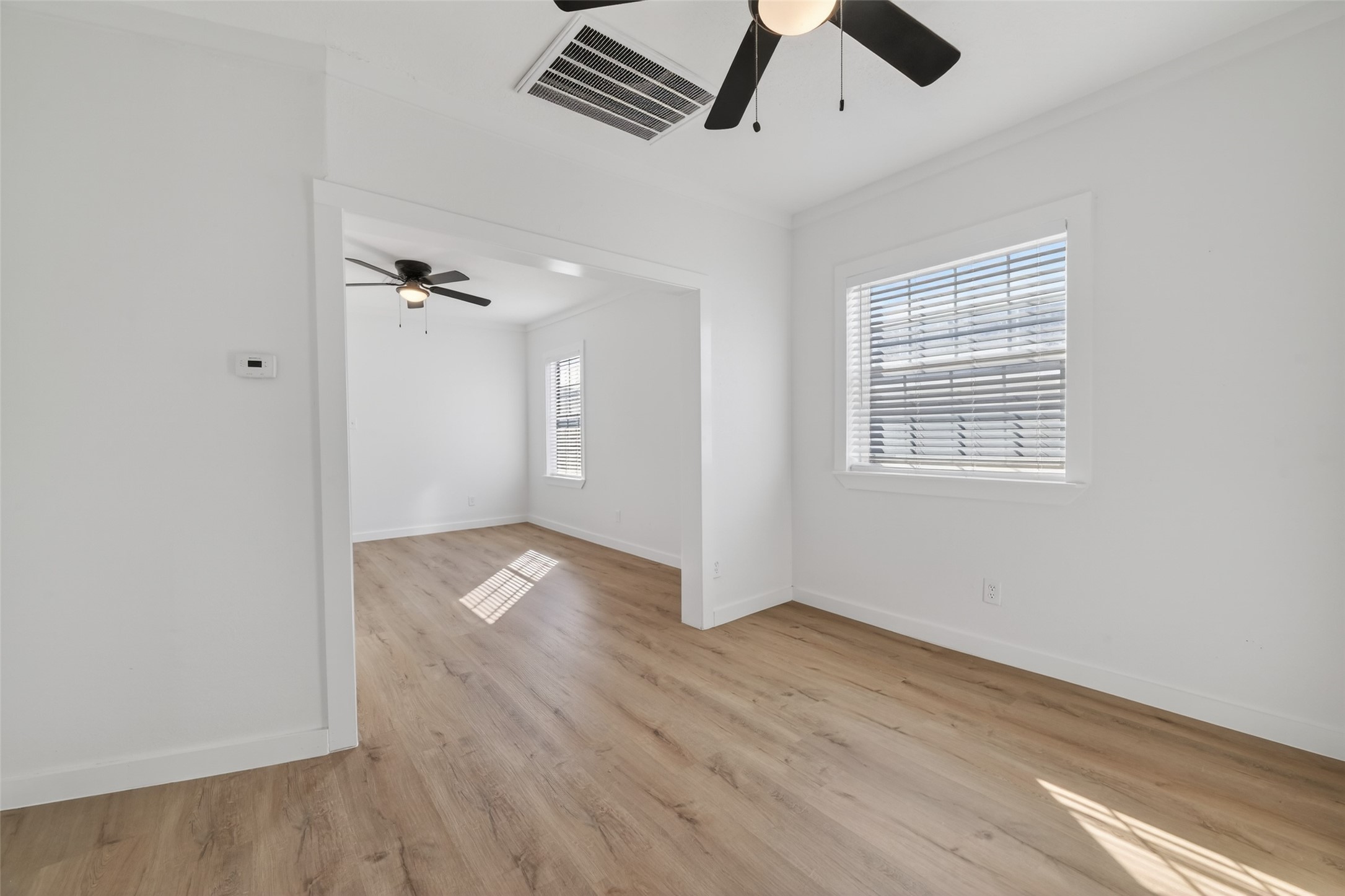 2202 Hutchins Street, Unit C Houston, TX 77003 - Photo 15 of 27 an empty room with wooden floor and windows