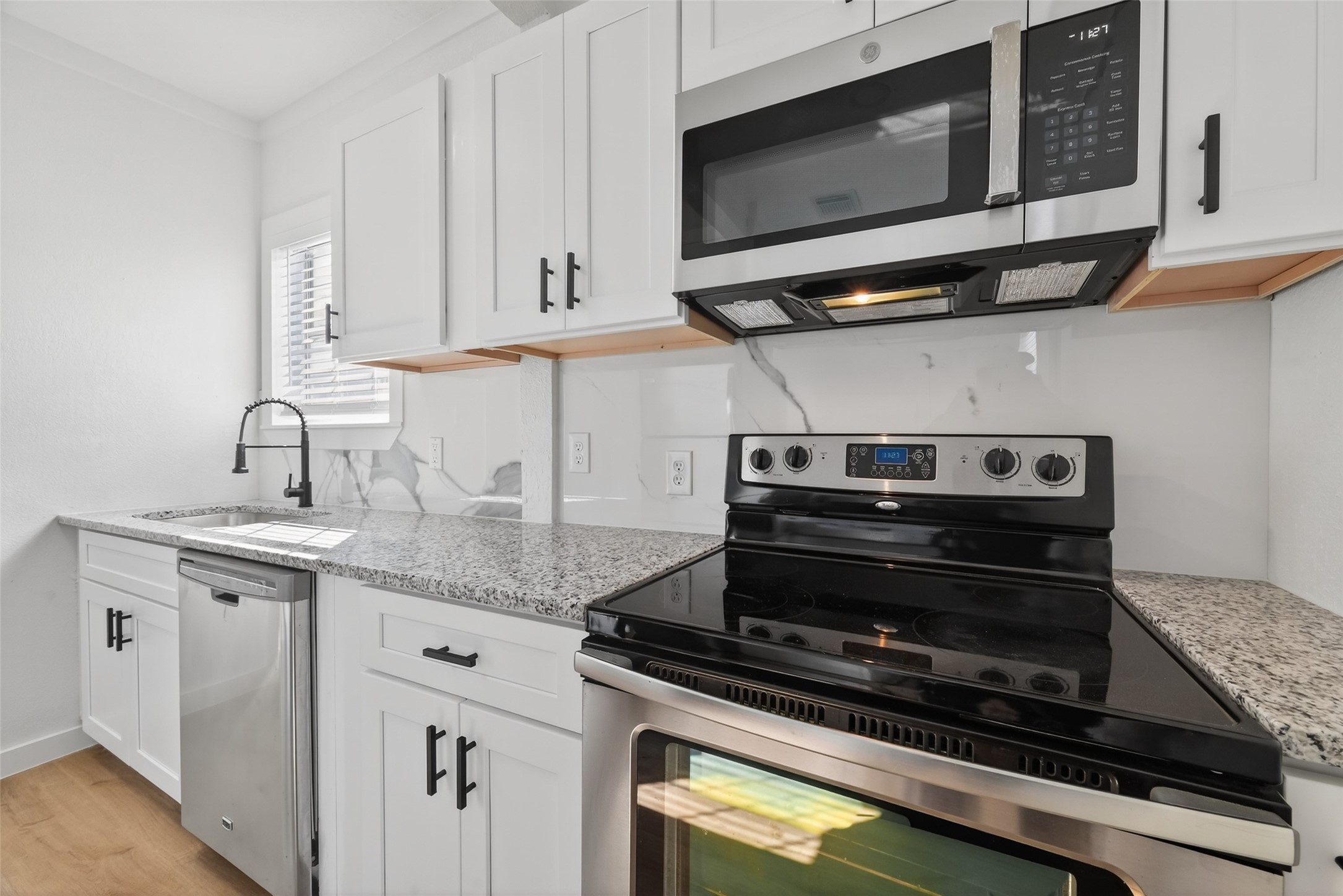 2202 Hutchins Street, Unit C Houston, TX 77003 - Photo 10 of 27 a kitchen with stainless steel appliances granite countertop a stove and a microwave