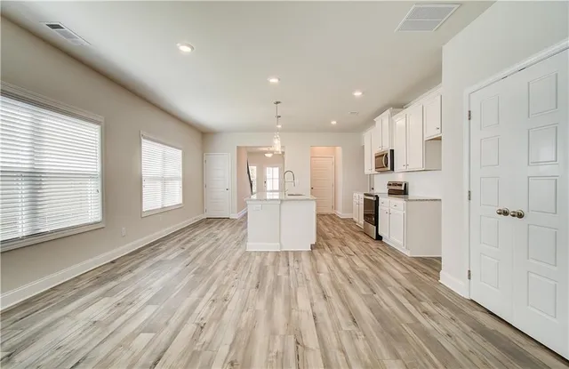 a view of kitchen with wooden floor and electronic appliances