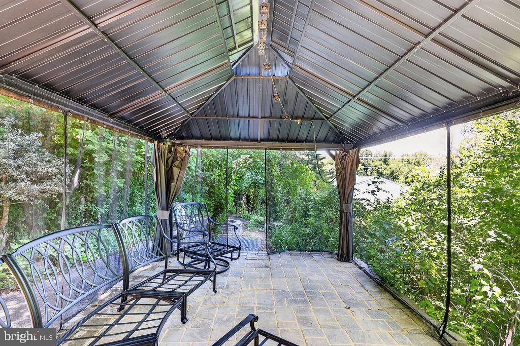 8471 Great Lake Lane Springfield, VA 22153 - Photo 50 of 65 a view of a patio with a table chairs and a patio