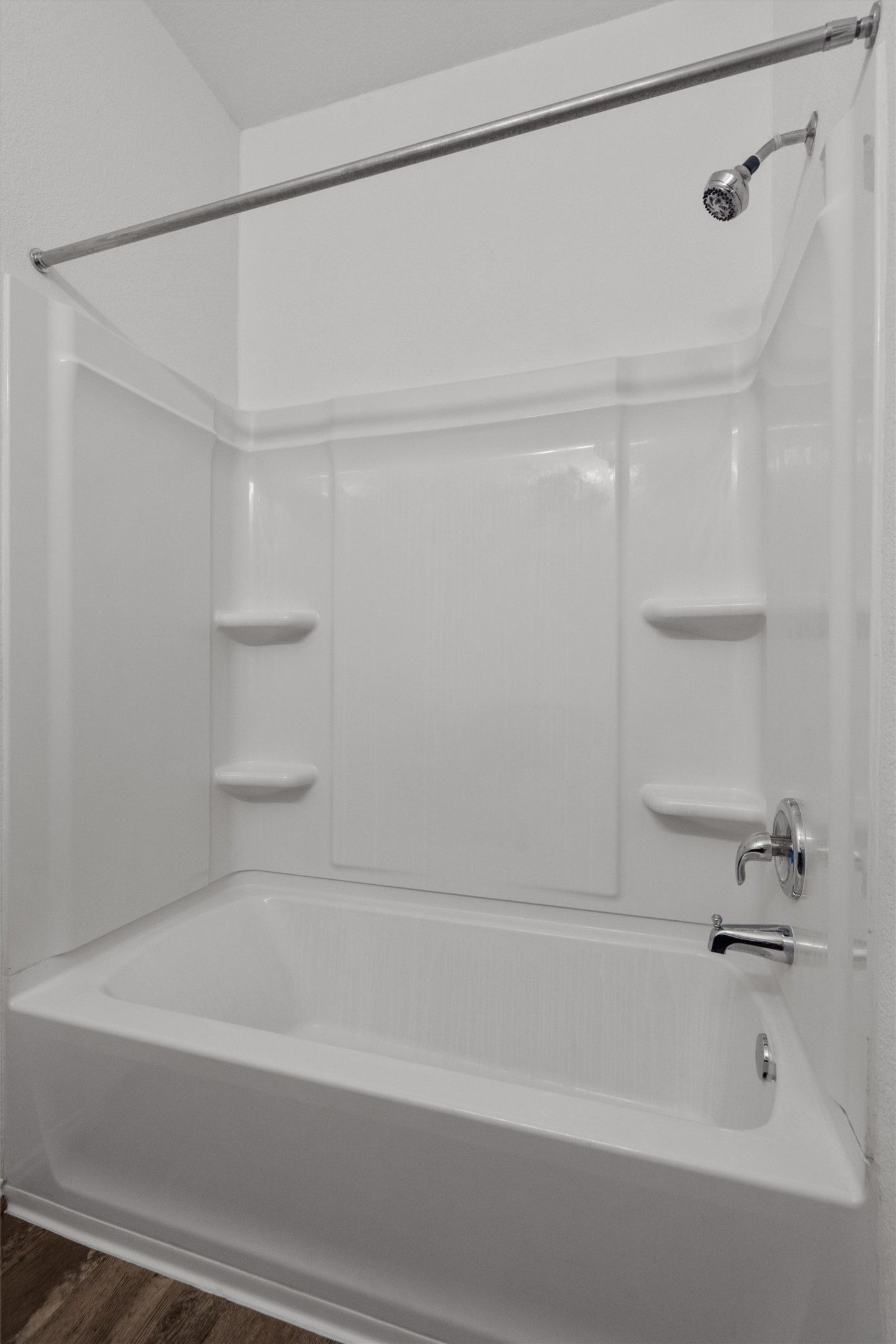 791 Circle Way Jarrell, TX 76537 - Photo 19 of 36 White bathtub and shower combination unit featuring an integrated showerhead and chrome fixtures