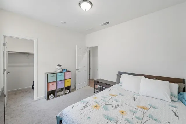 a bed room with a bed and a chair