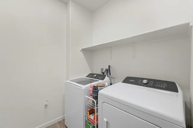 a view of walk in closet with clothes